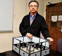 Dr. Seung-yun Kim with a model of the ShepRobo Fest Mech-Warfare arena.